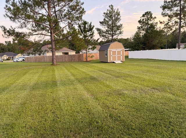 Evening lawn mowing service with clean stripes in Minnesota